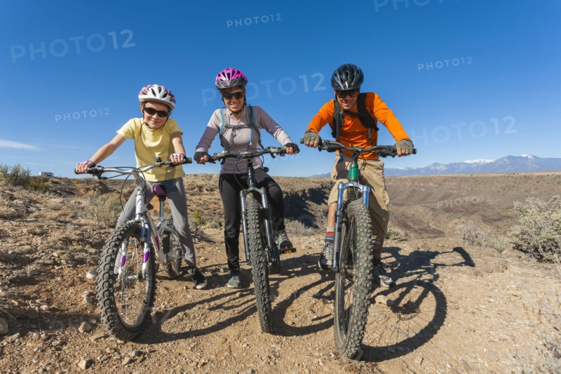 Family sitting on mountain bikes