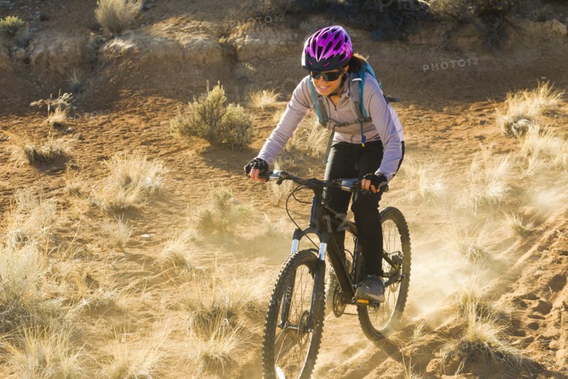 Hispanic woman mountain biking