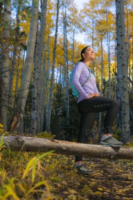 Hispanic woman hiking in woods