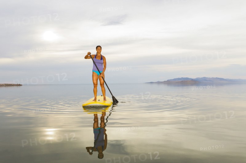 Filipino woman riding paddle board