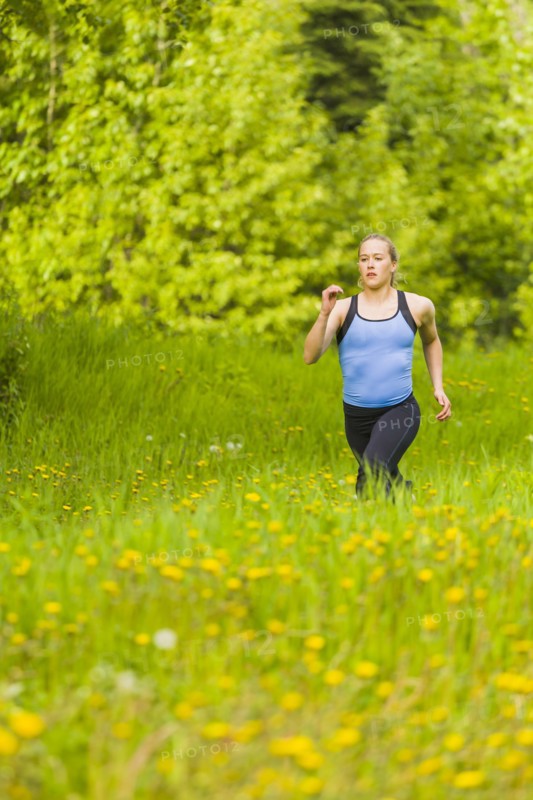Caucasian woman running in tall grass