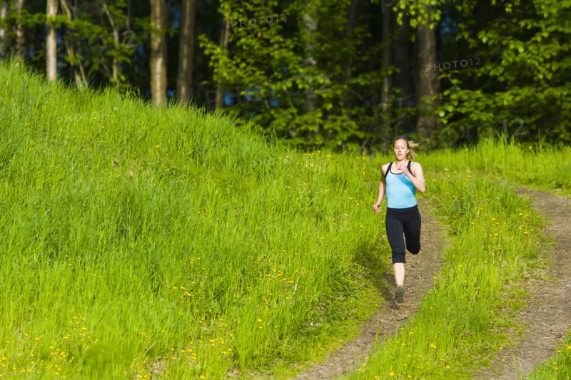 Caucasian woman running on path