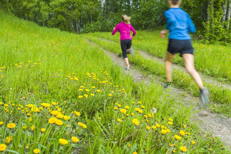 Caucasian women running on path