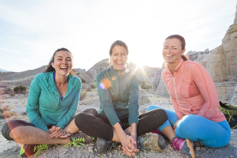 Laughing women sitting in canyon