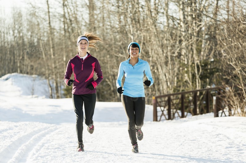 Women running on snow in winter