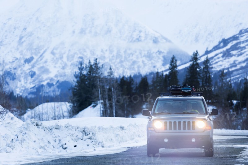 Headlights shining from car driving in winter