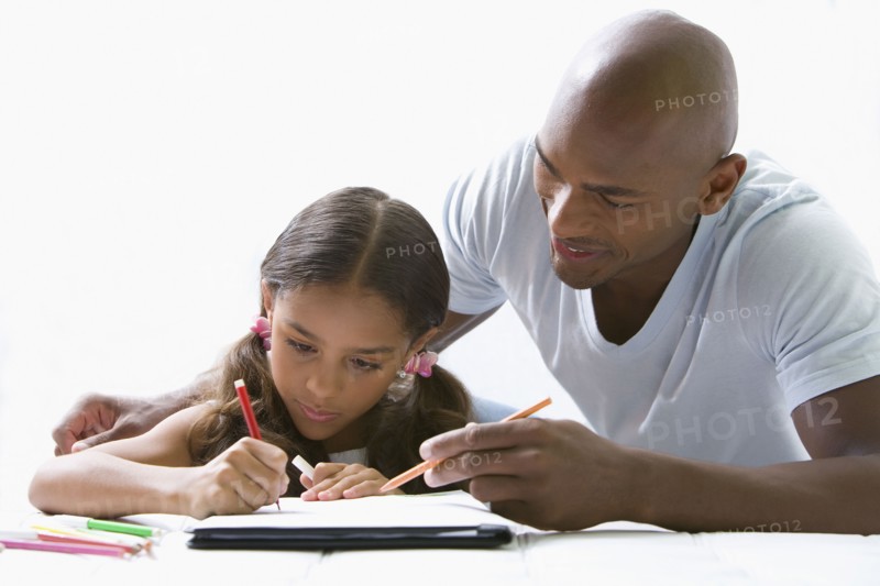 Mixed race father helping daughter with homework