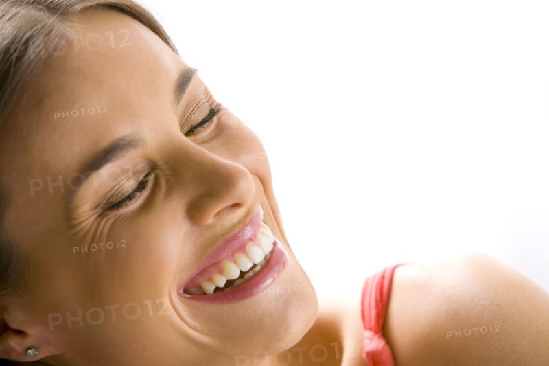 Mixed race woman smiling with eyes closed