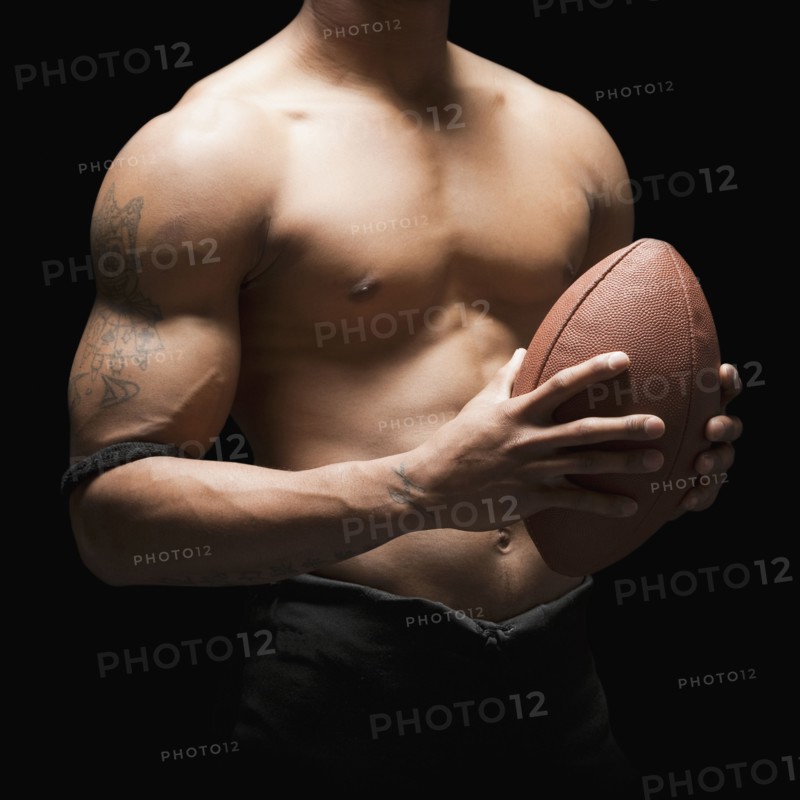 Midsection of bare chested football player