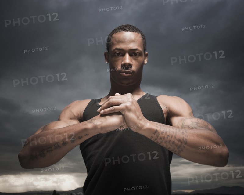 African man with hands clasped