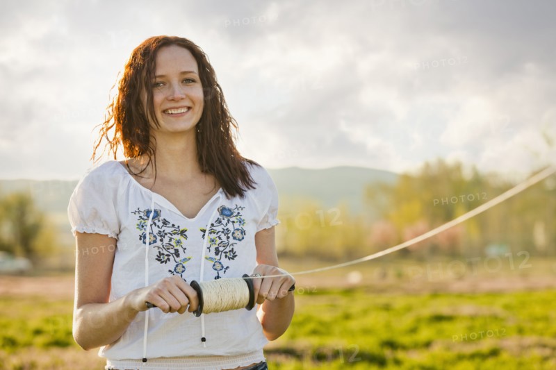 Caucasian woman flying kite
