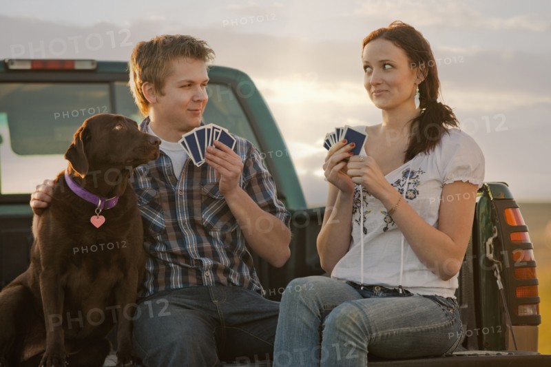 Caucasian couple playing cards in truck