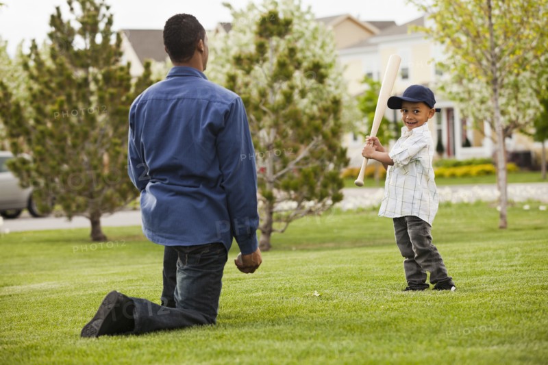 Father teaching son to play baseball