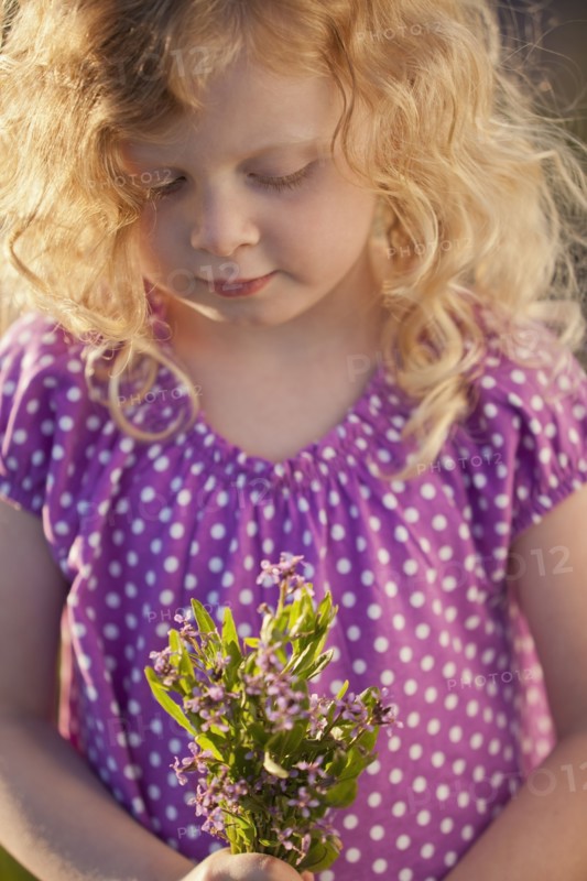Caucasian girl picking flowers