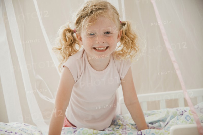 Smiling Caucasian girl in bed