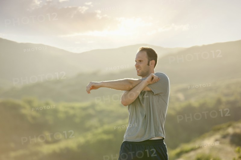 Caucasian man stretching before exercise
