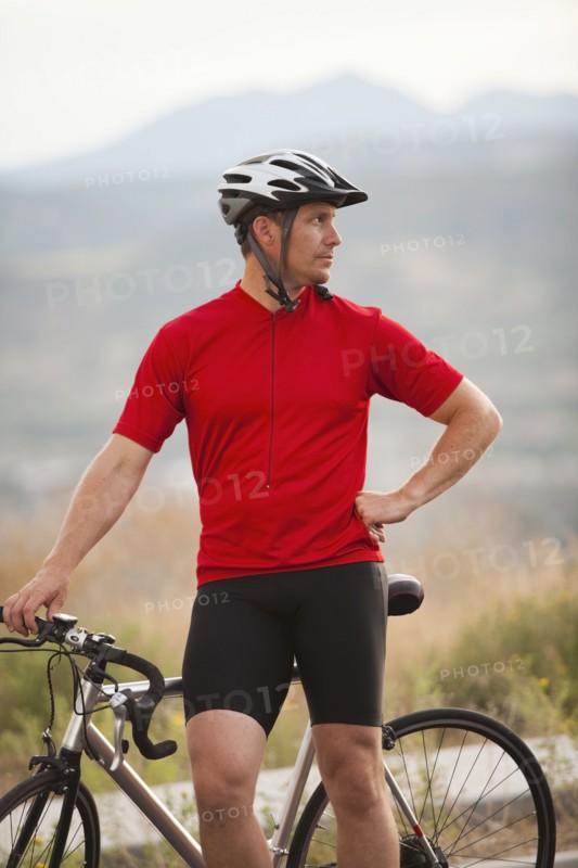 Caucasian man standing near bicycle