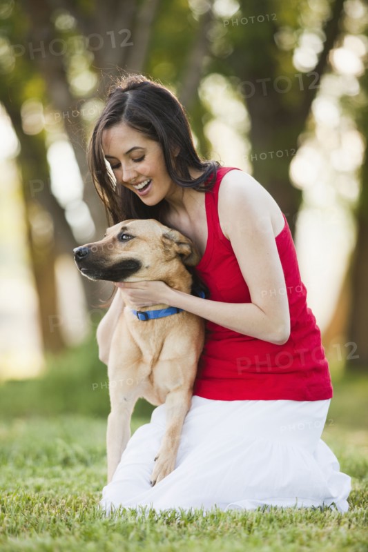 Caucasian woman petting dog