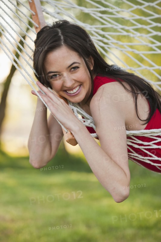 Caucasian woman laying in hammock