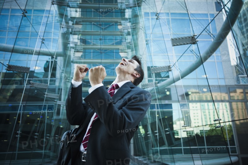 Caucasian businessman cheering outdoors