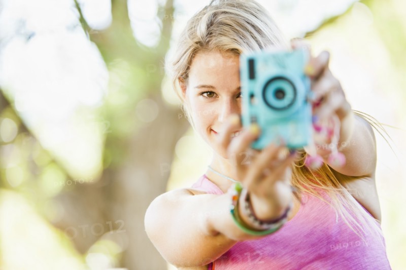 Caucasian woman taking photographs
