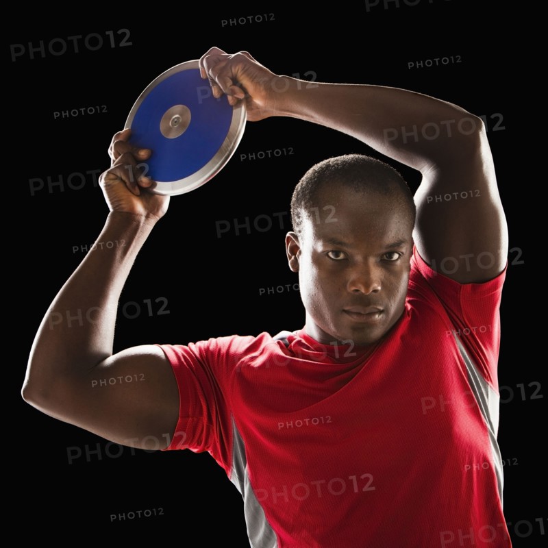 African American man holding track and field discus