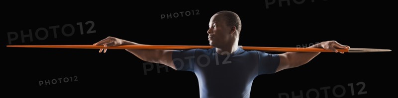 African American man holding track and field javelin