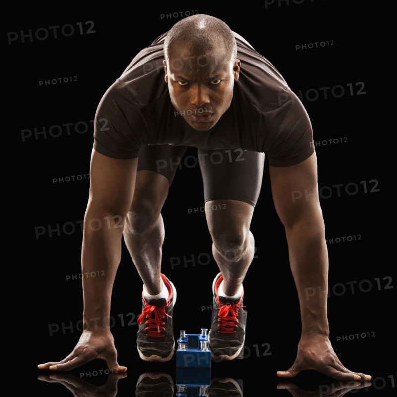 African American runner crouching at starting block