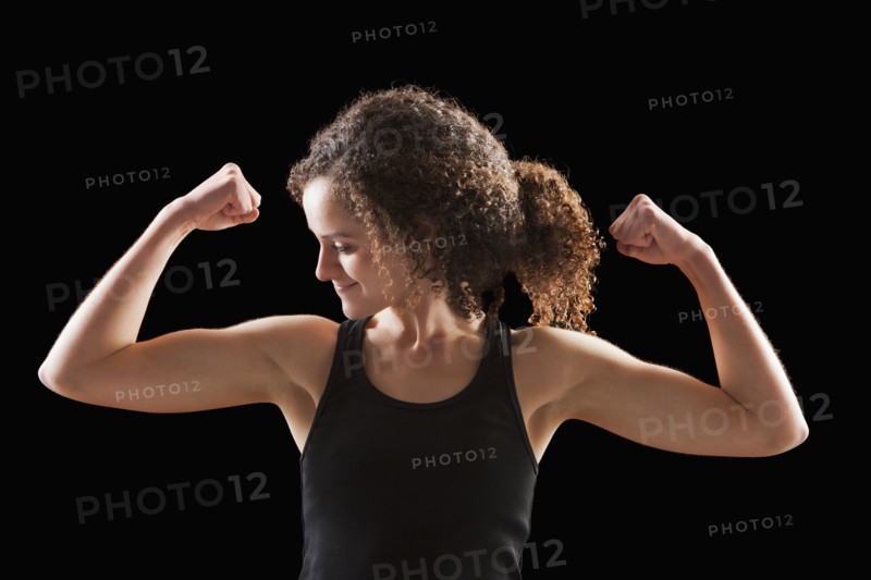 Caucasian woman flexing biceps