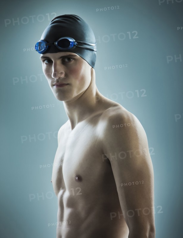 Caucasian teenage boy in swim cap and goggles