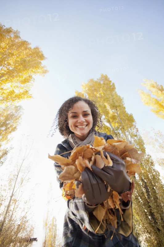 Caucasian woman holding autumn leaves