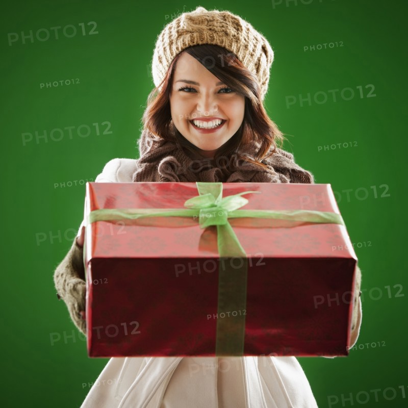 Mixed race woman holding Christmas gift