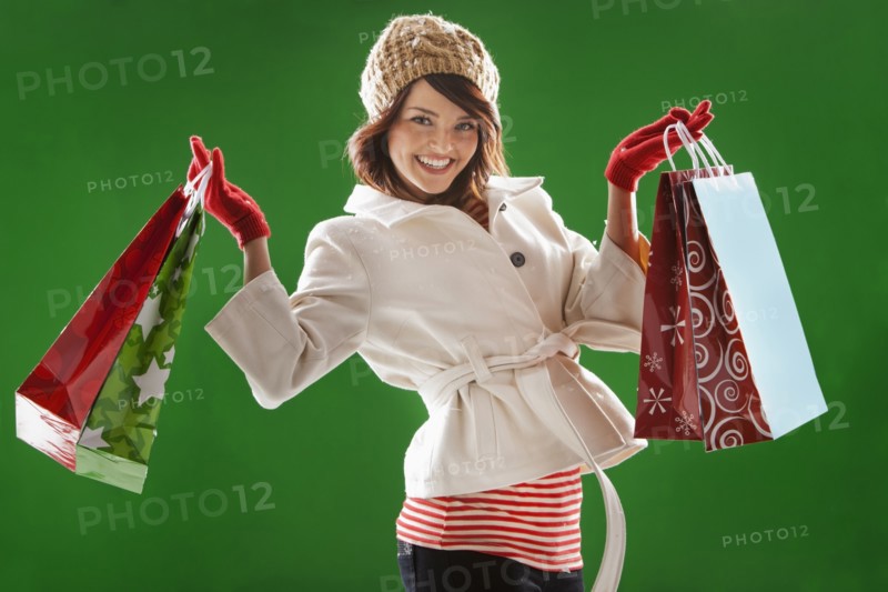 Mixed race woman holding Christmas shopping bags