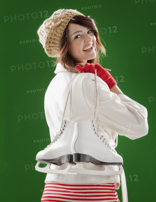 Mixed race woman carrying ice skates