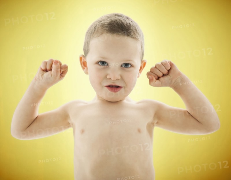 Caucasian boy flexing his biceps