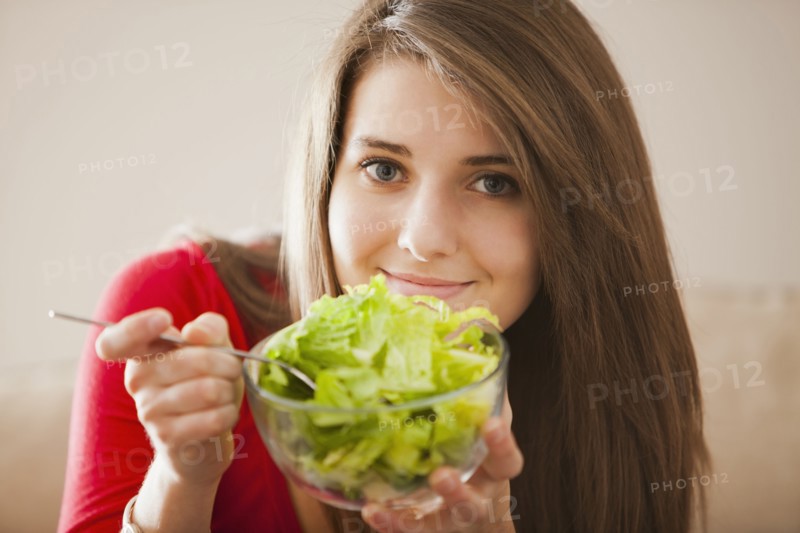 Caucasian woman eating salad