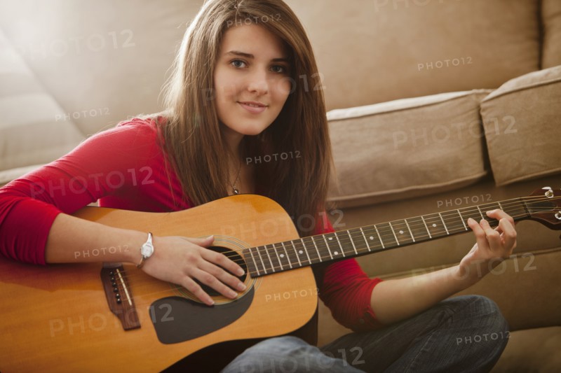 Caucasian woman playing guitar