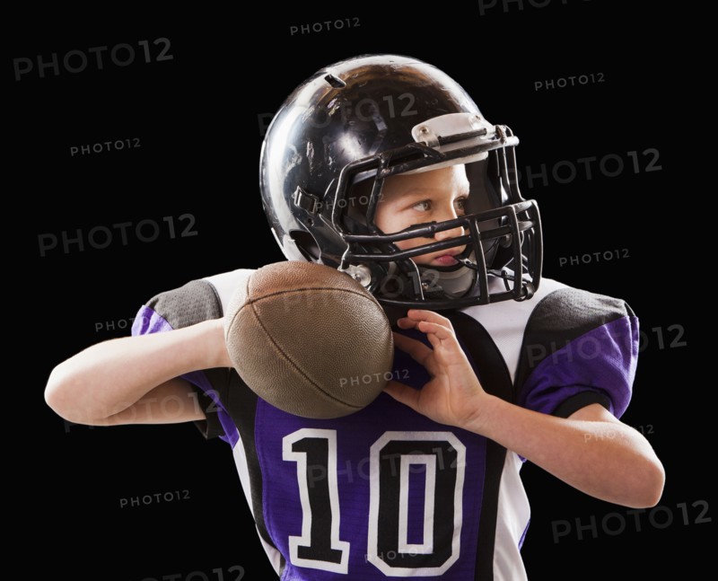 Caucasian football player throwing football