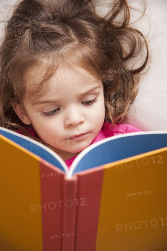 Caucasian girl reading a book