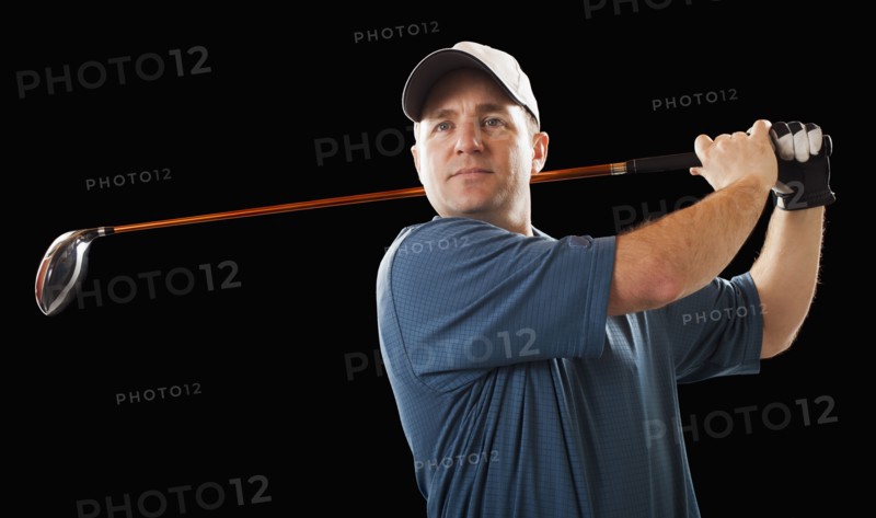 Caucasian golfer swinging golf club