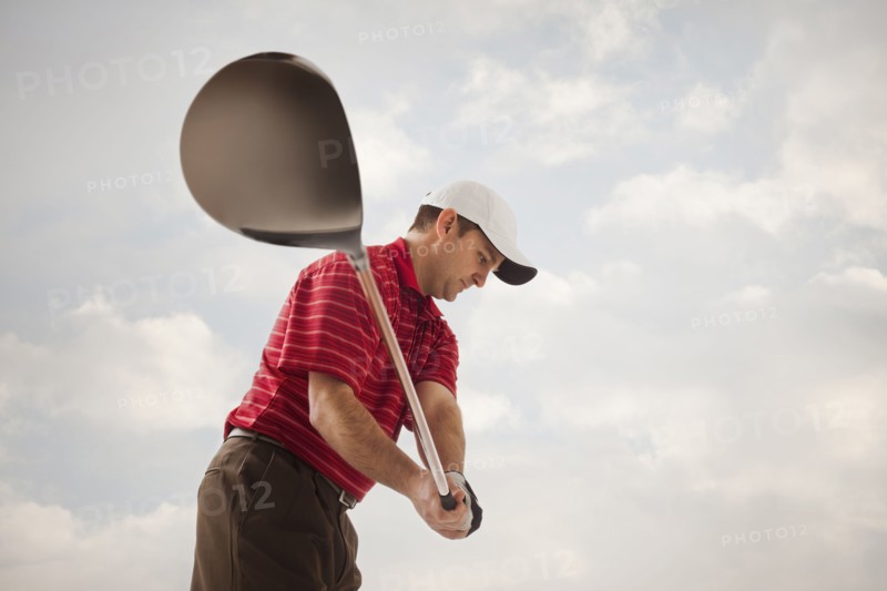 Caucasian golfer swinging golf club