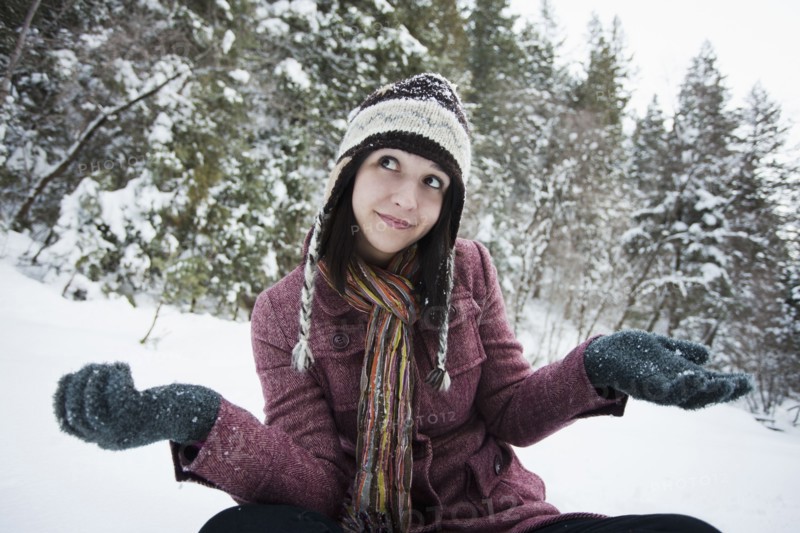 Caucasian woman sitting in the snow