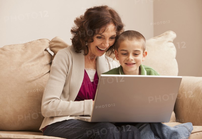 Caucasian grandmother and granddaughter using laptop