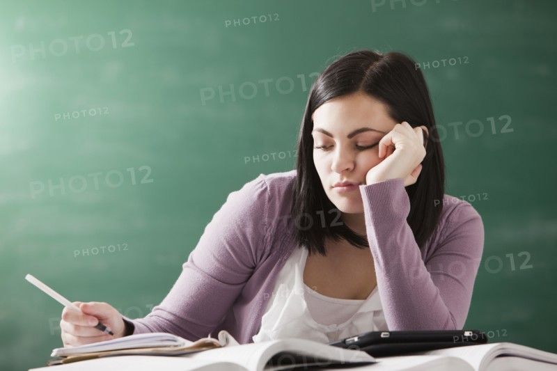 Bored Caucasian student doing homework