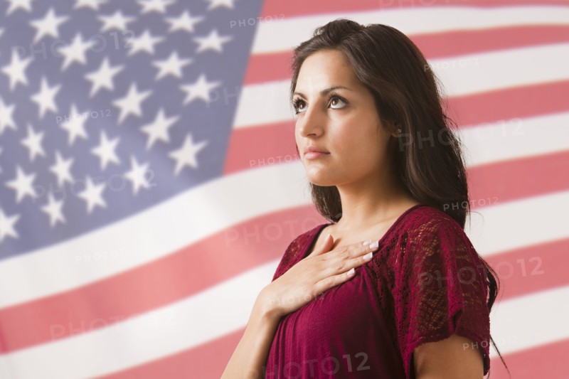 Mixed race woman saluting American flag