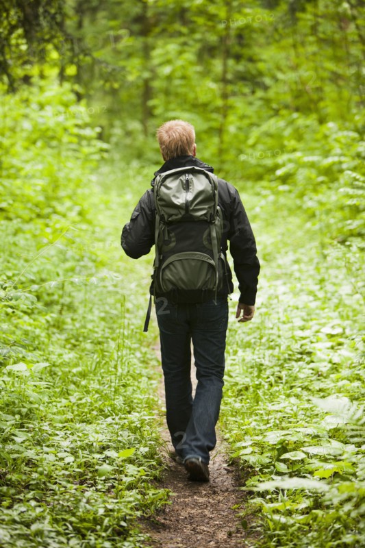 Caucasian man hiking in woods