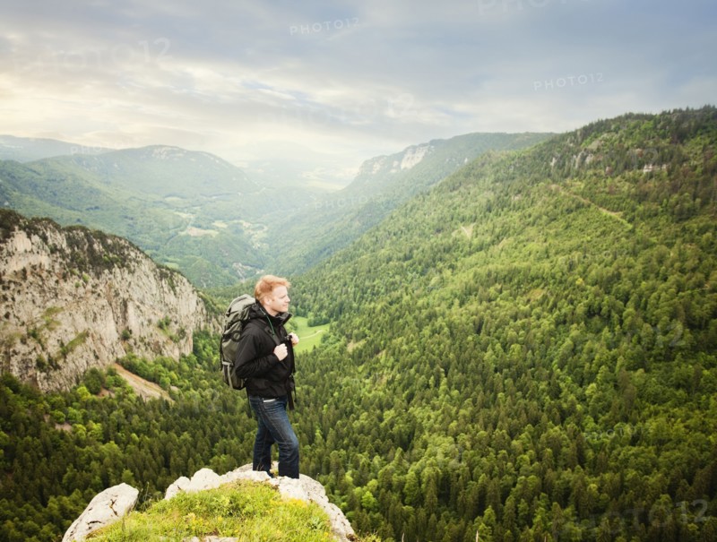 Caucasian man standing on remote cliff