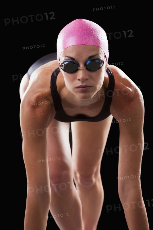 Caucasian swimmer in swim cap and goggles