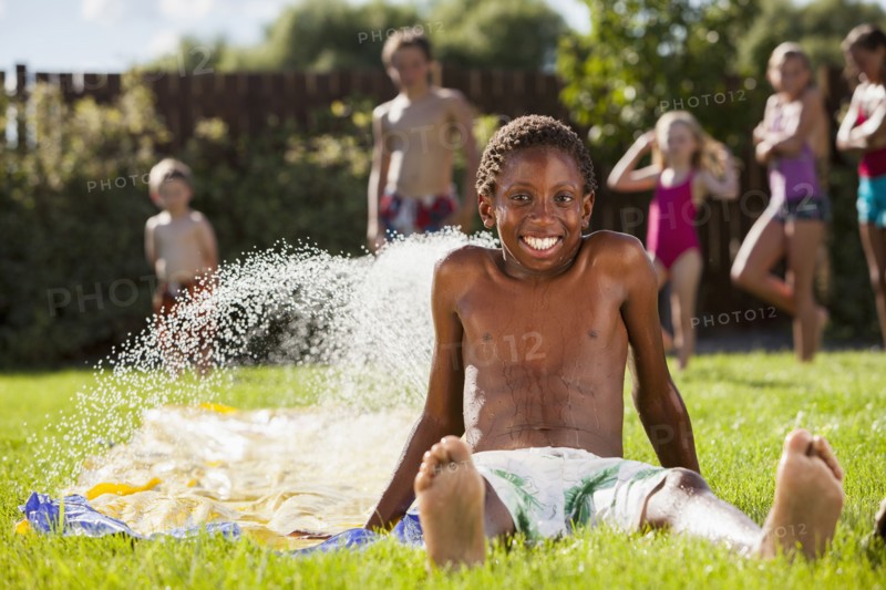 Black boy playing in water