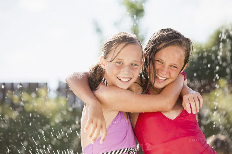 Caucasian girls playing in water